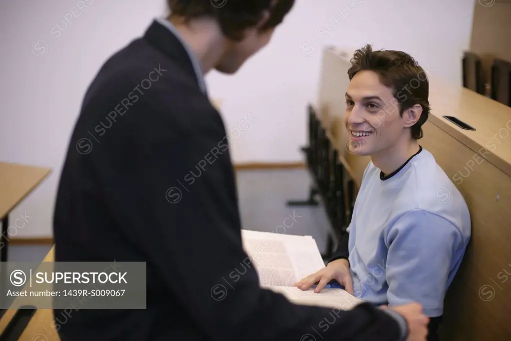 Two young men in a lecture theatre