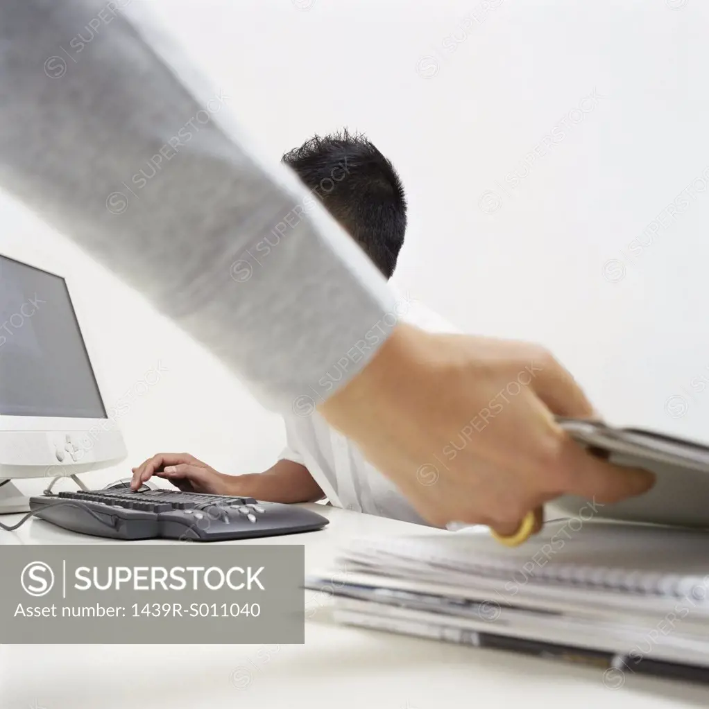 Office worker reaching for file