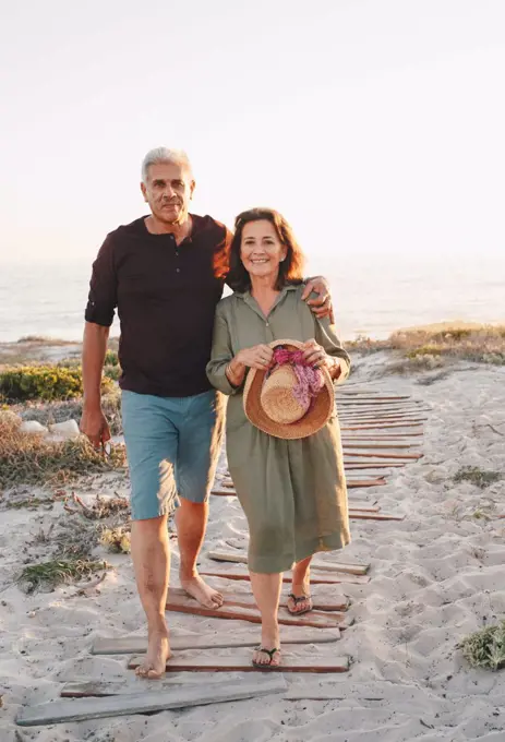 Senior couple taking walk on beach