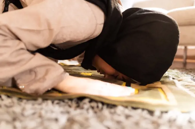 Muslim woman praying, in sujud position