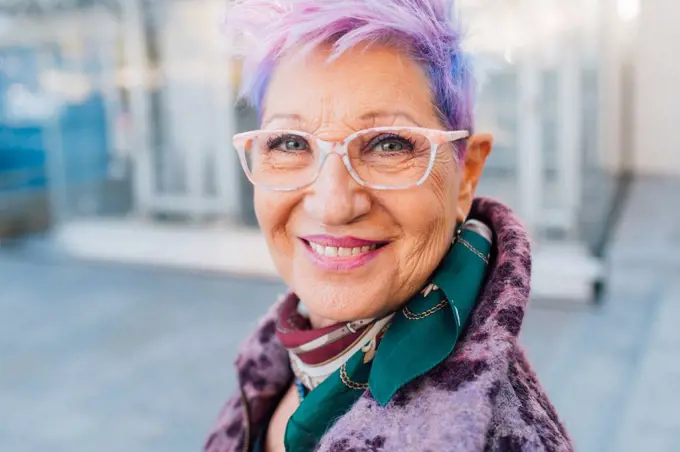 Italy, Portrait of smiling fashionable senior woman