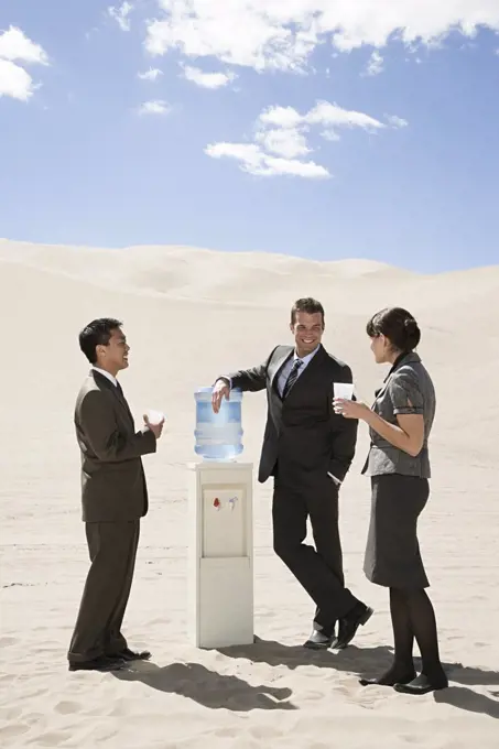 People around water cooler in the desert