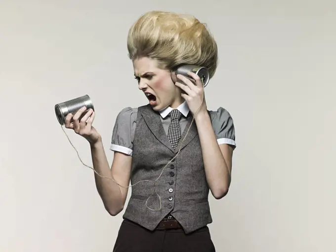 Businesswoman on tin can phone