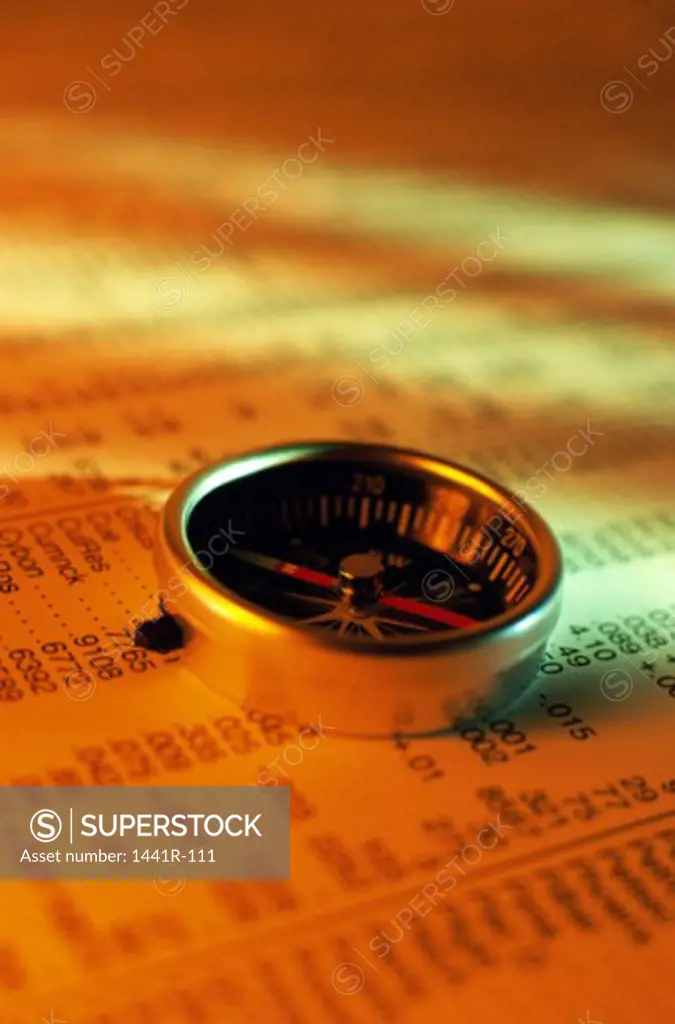 Close-up of a compass on stock listings