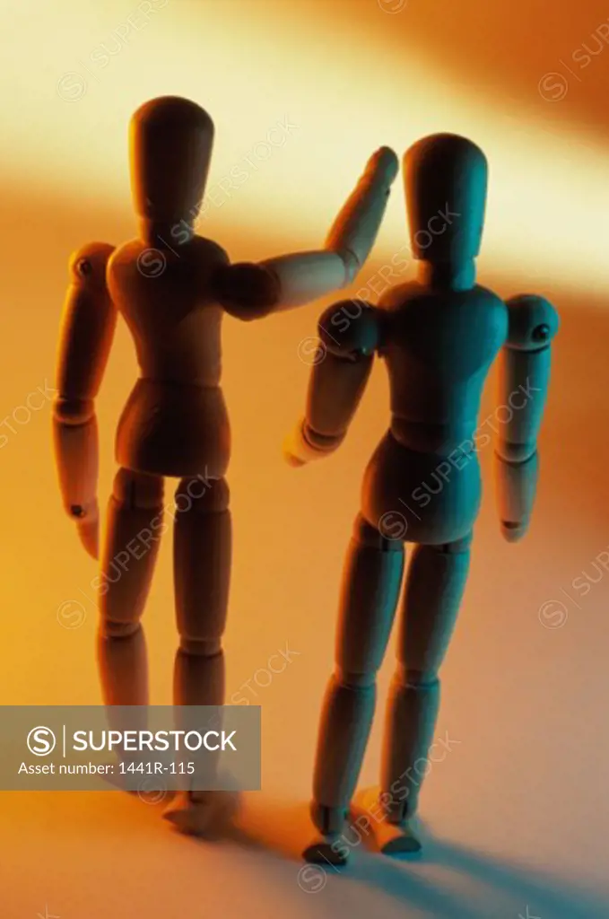 Close-up of two wooden dolls