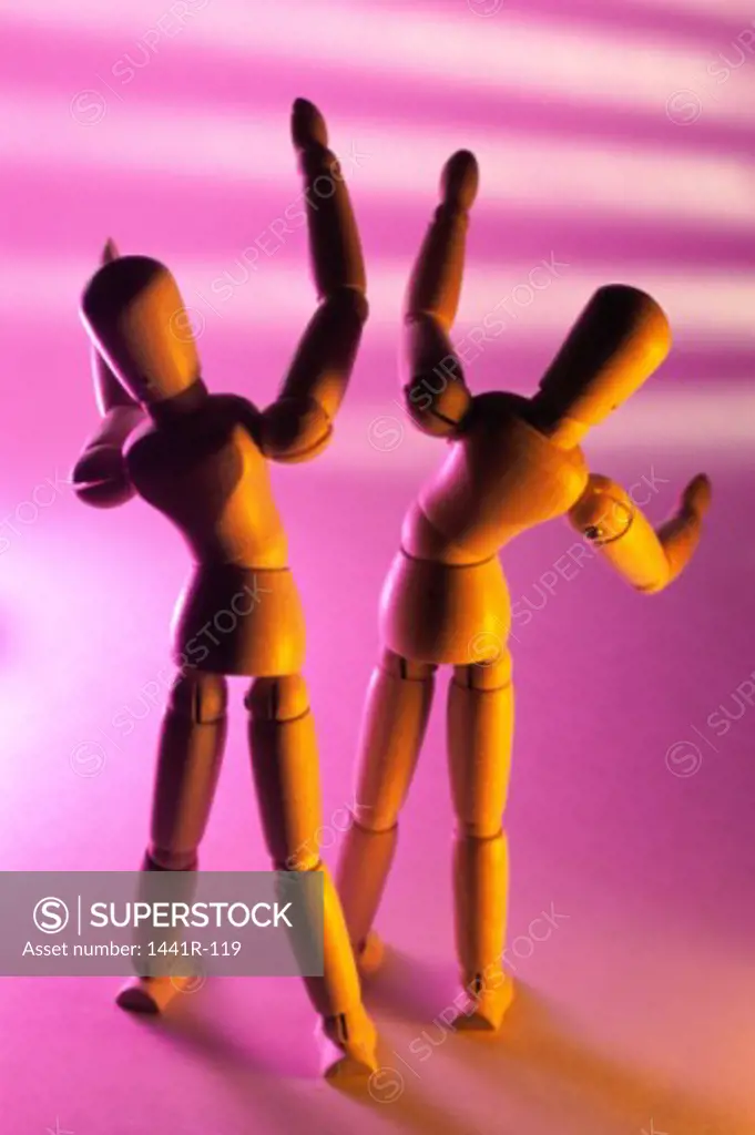 Close-up of two wooden dolls