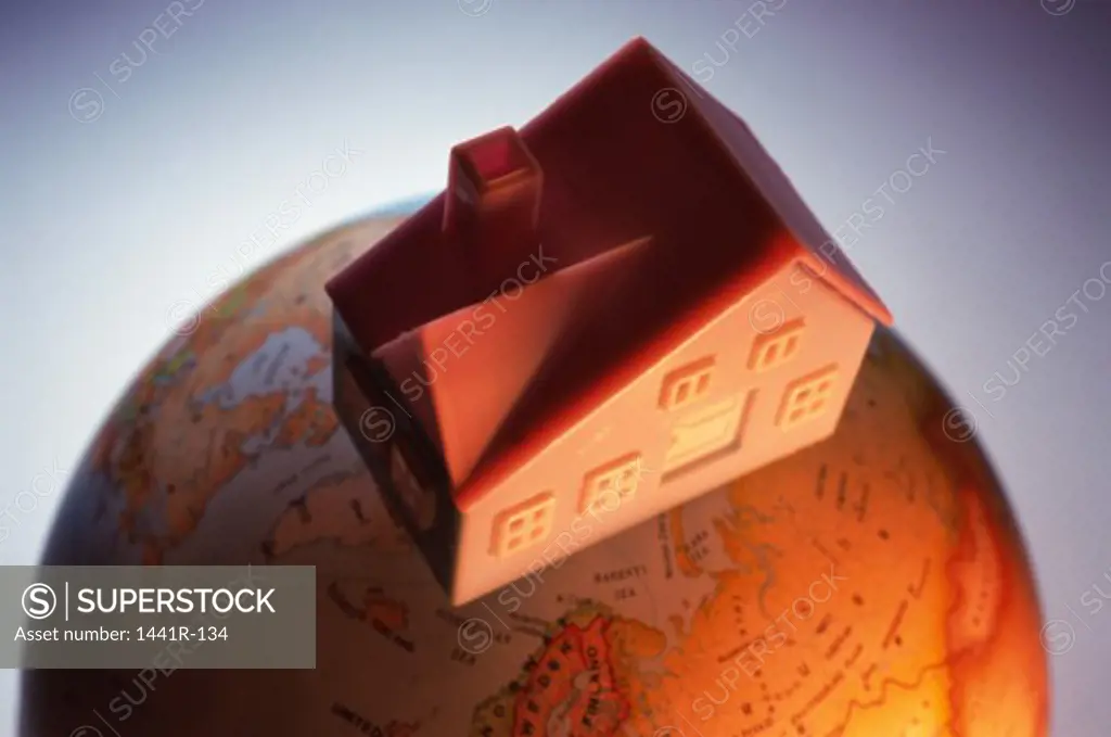 Model of a house on a globe