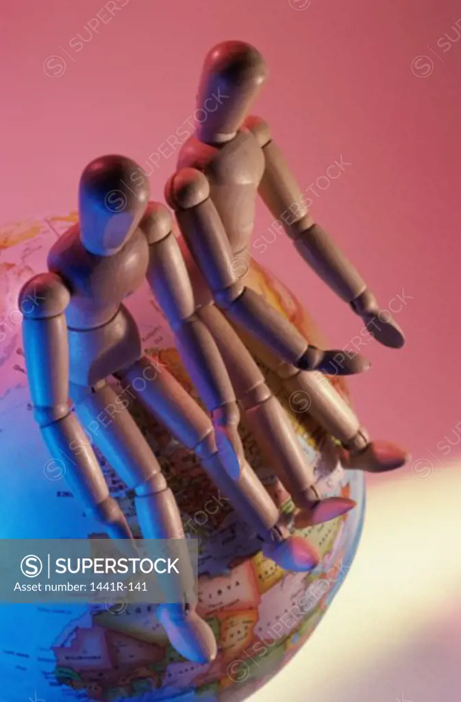 Two dolls on a globe
