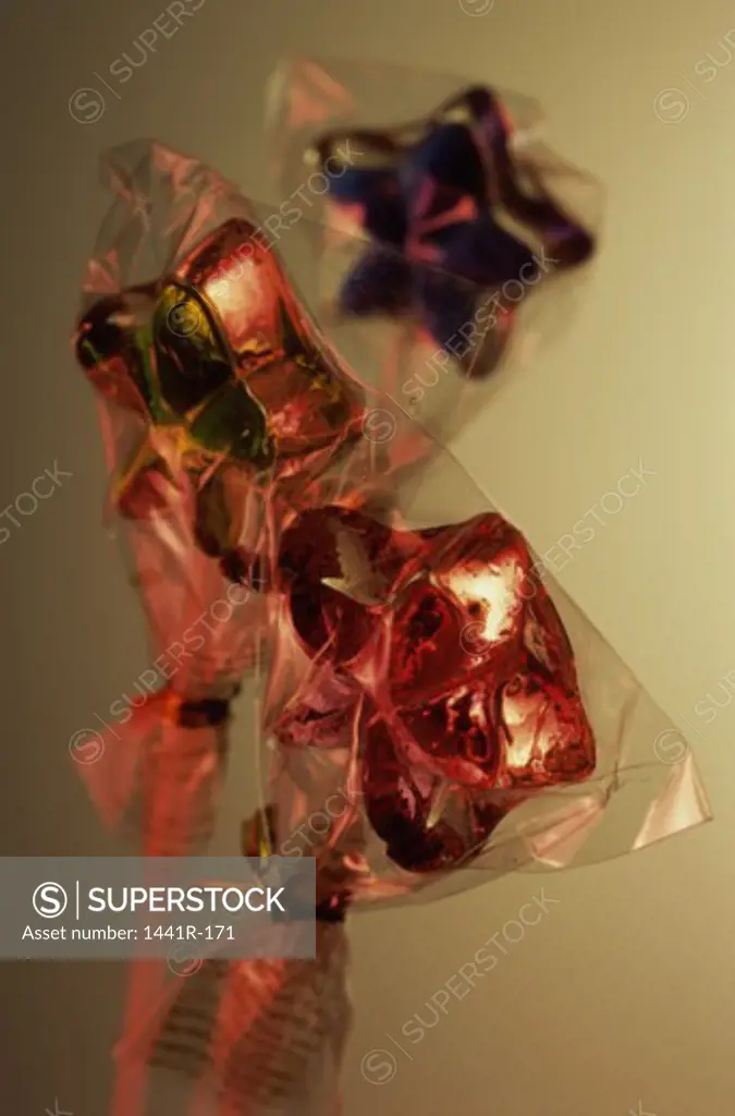 Close-up of foil wrapped chocolate lollipops