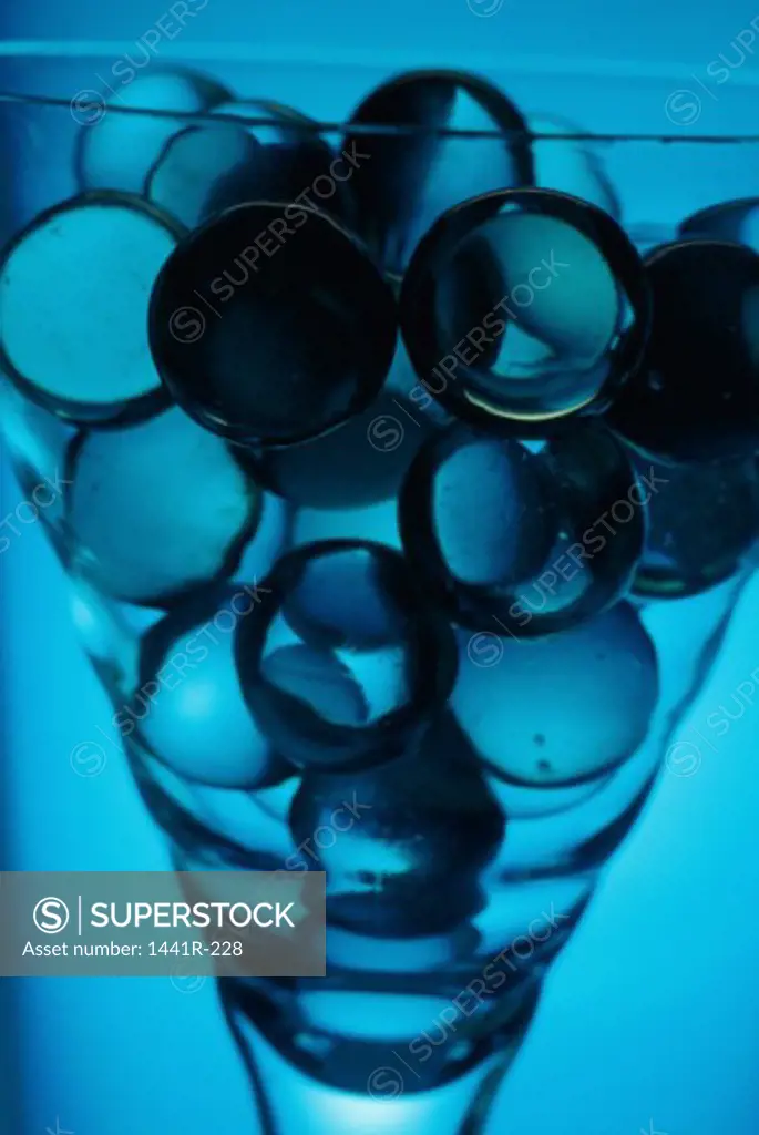 Close-up of marbles in a glass