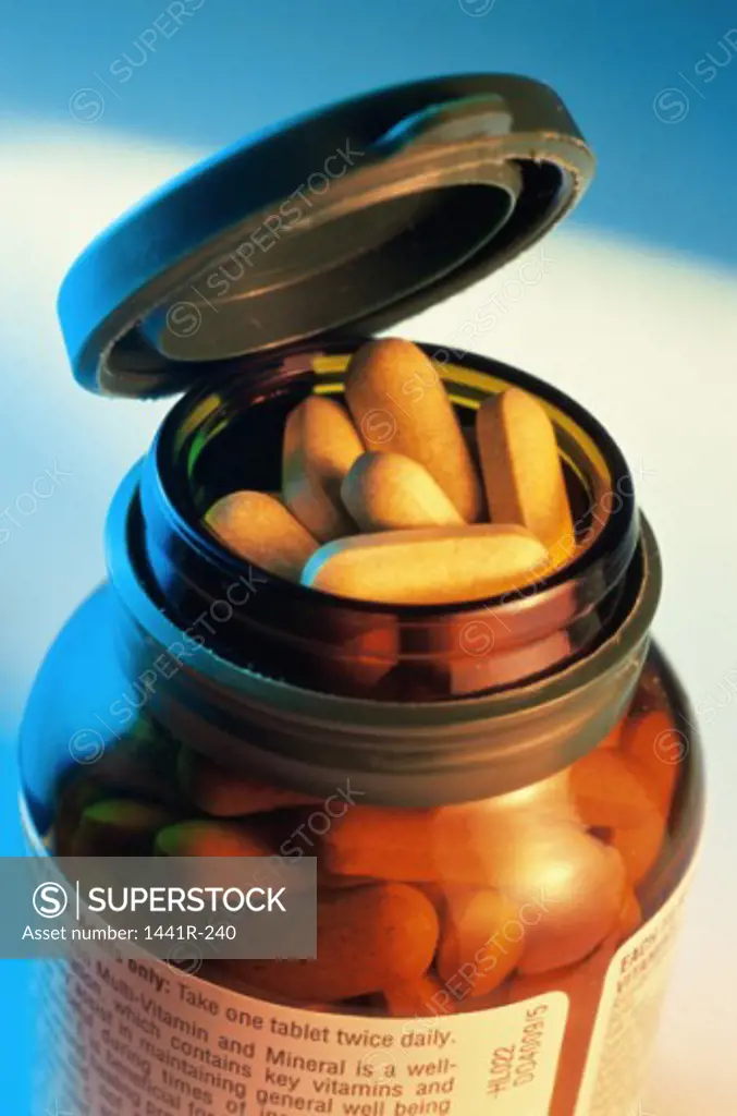 Close-up of an open bottle of vitamin tablets