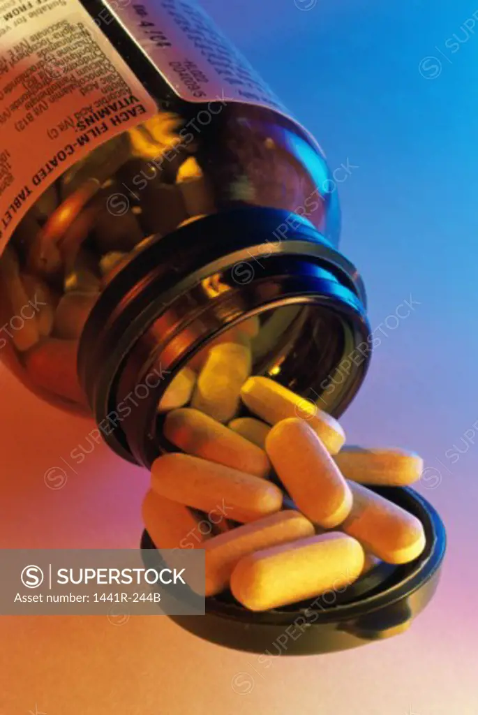 Close-up of an open bottle of vitamin tablets