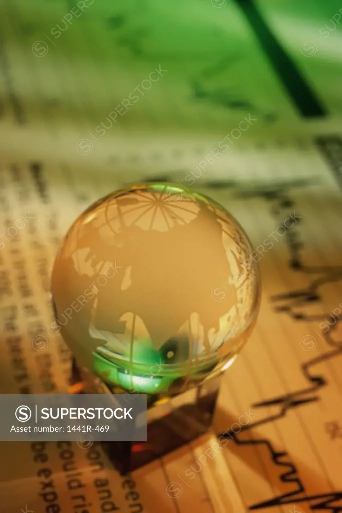 Close-up of a crystal globe on stock listings