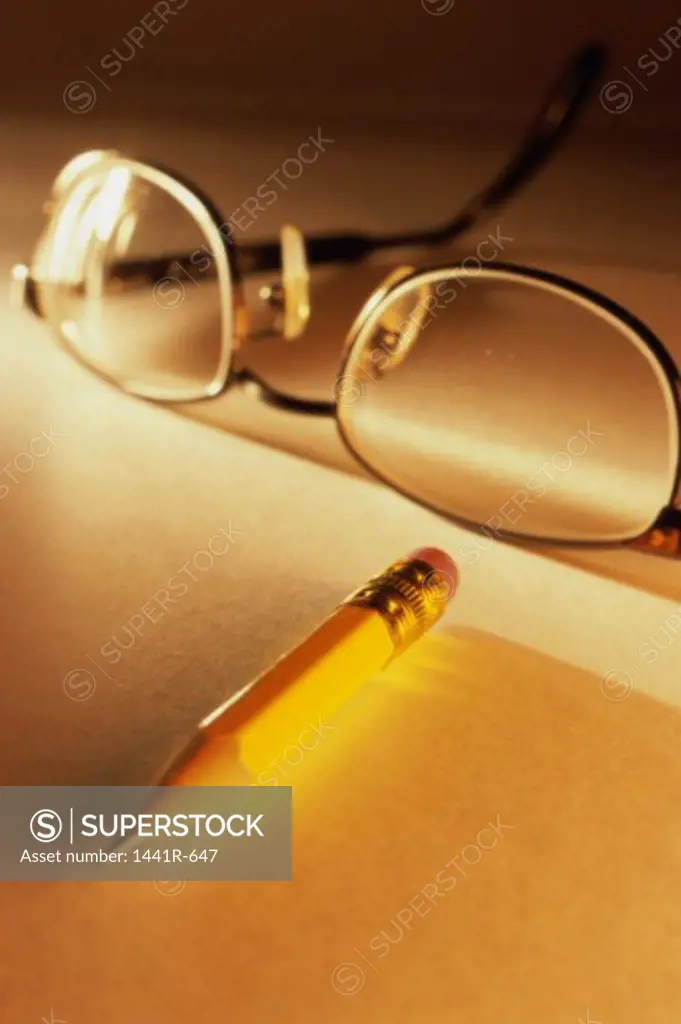 Close-up of a pencil near eyeglasses