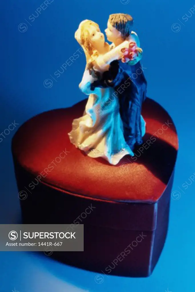 High angle view of a bride and groom figurine on a box