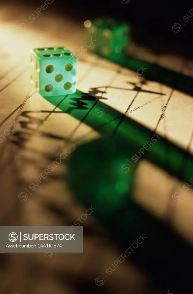 Close-up of a pair of dice on a financial report