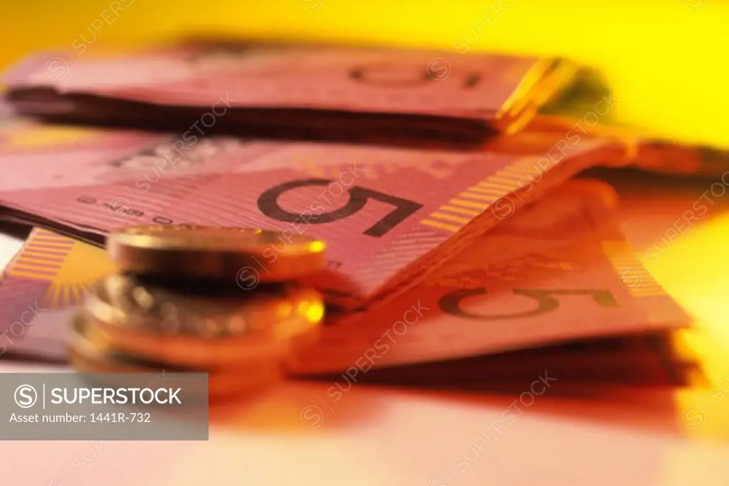 Close-up of paper currency and coins