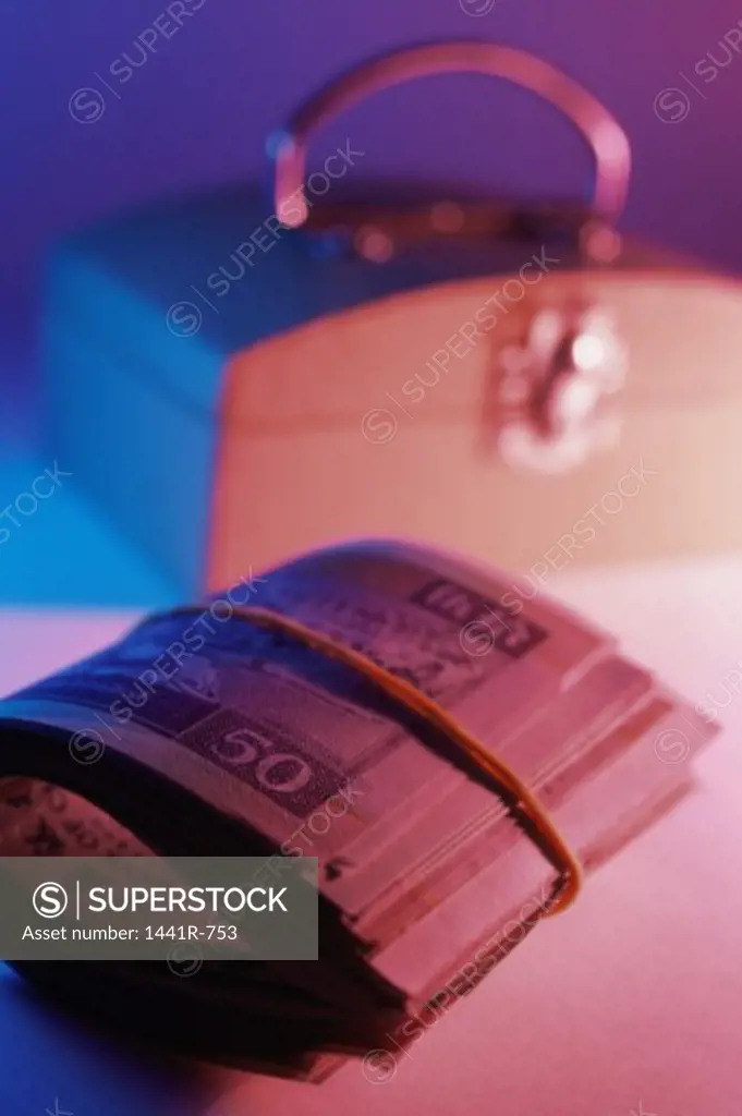Close-up of banknotes next to a safe