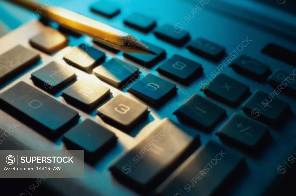 Close-up of a pencil on a calculator