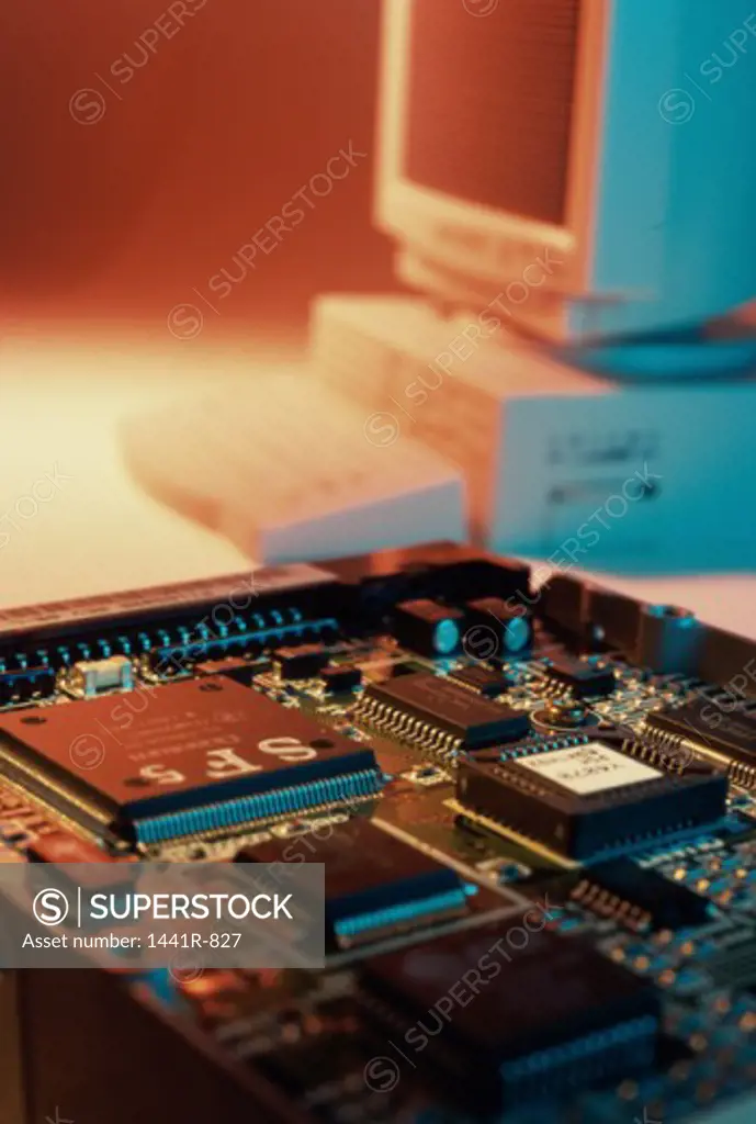 Circuit board with a computer in the background