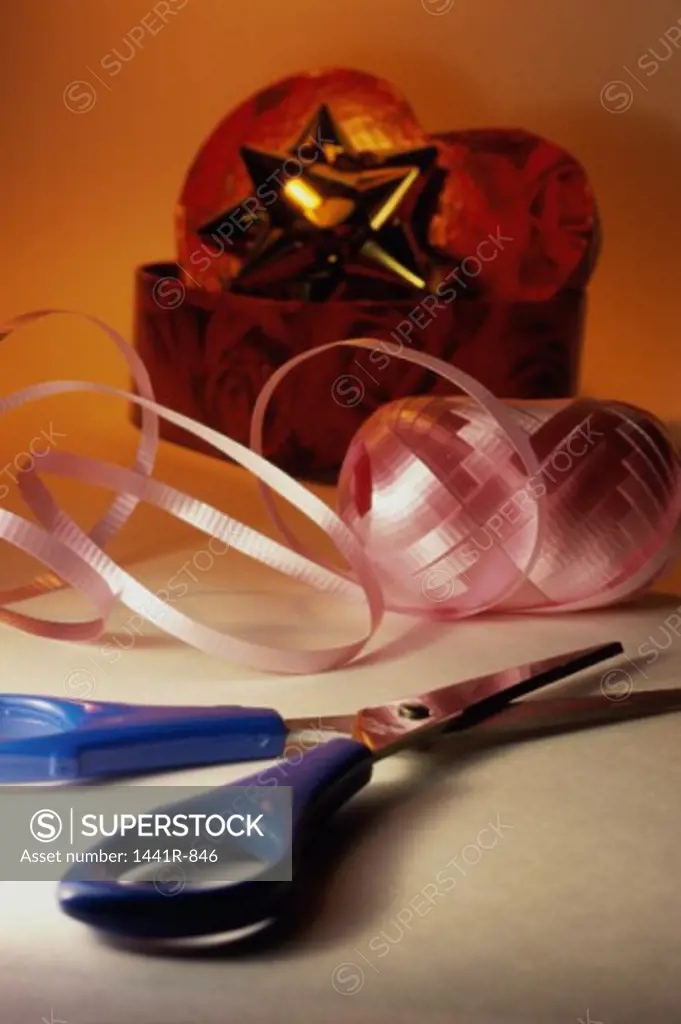 Pair of scissors and a roll of ribbon