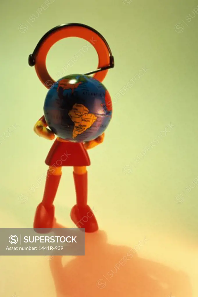Close-up of a doll holding a globe