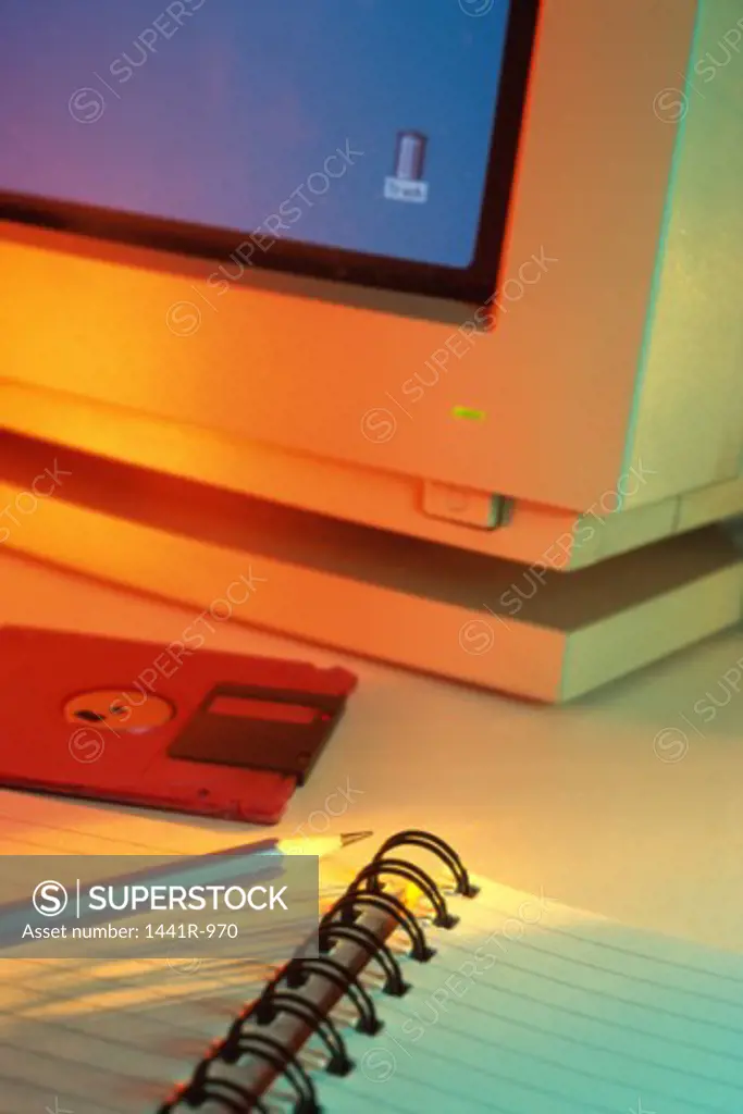 Close-up of a computer monitor near a floppy disk