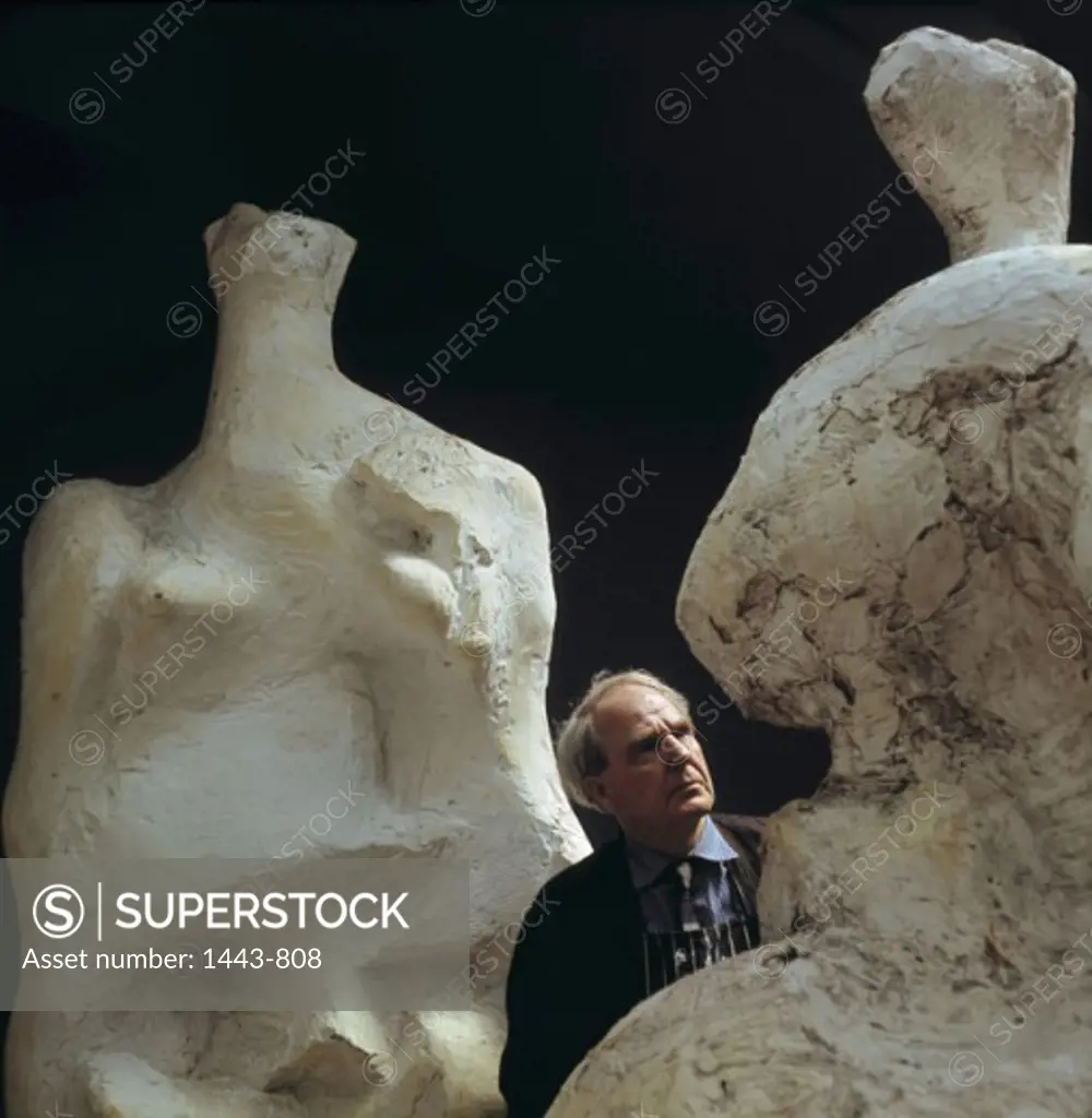 Henry Moore in His Studio Between Original Casts of His Sculptures "Relief No. 2" & Seated Woman" 1966 Artist Unknown Photograph