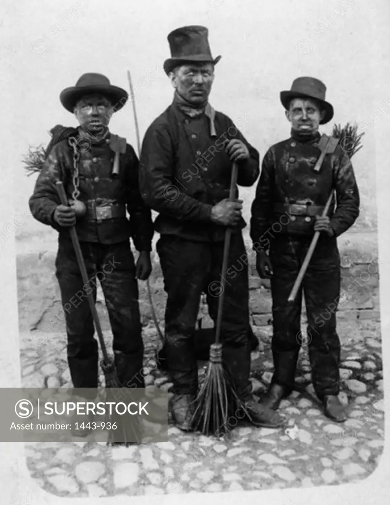 Portrait of three chimney sweeps standing together, 1915
