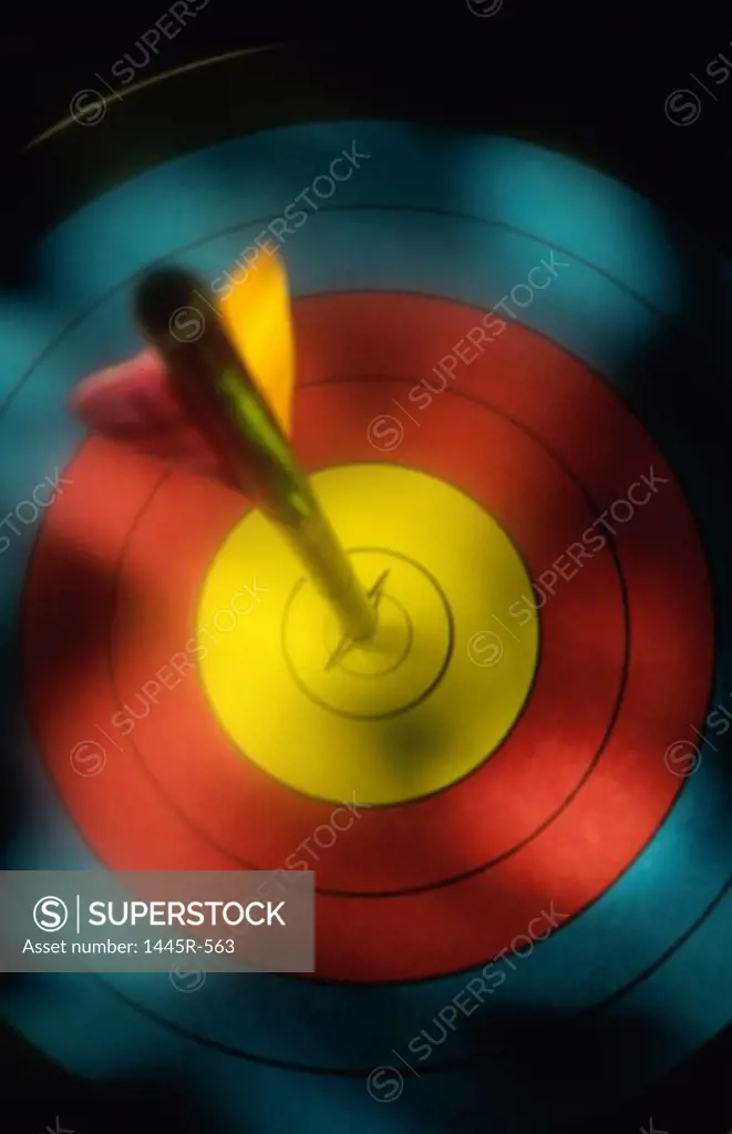 Arrow piercing the bull's eye of a target