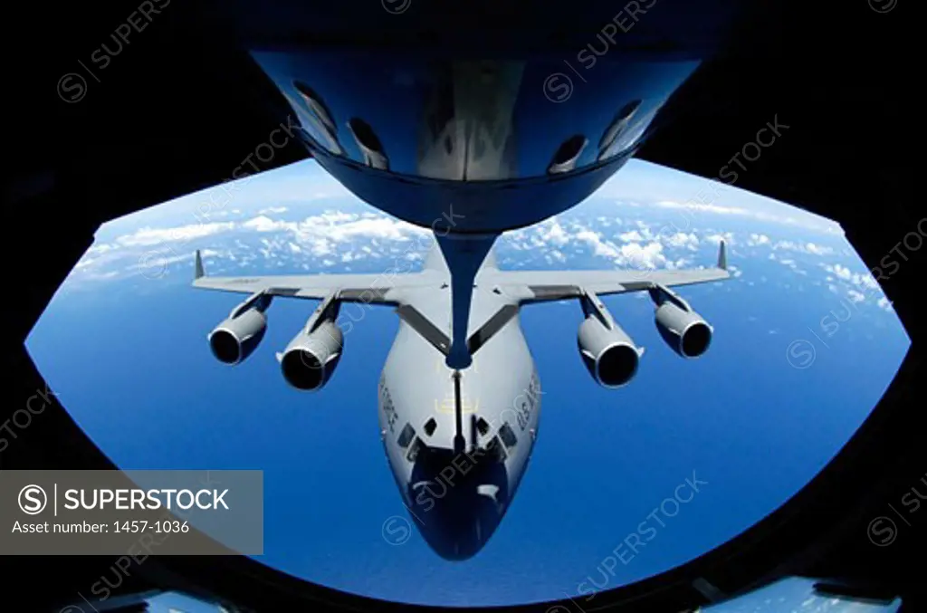 A C-17 Globemaster III from the 15th Airlift Wing at Hickam Air Force Base, Hawaii, receives fuel from a KC-135 Stratotanker from the 18th Wing, Kadena Air Base, Japan