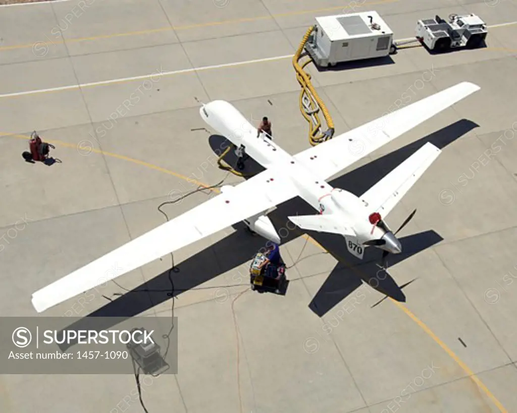 Ground crewmen prepare NASA's Ikhana remotely piloted research aircraft for another flight. Ikhana's infrared imaging sensor pod is visible under the left wing. A Predator B unmanned aircraft system is being used by NASA's Dryden Flight Research Center, Edwards, California, for a variety of environm