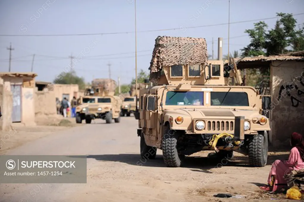 Humvees conduct security during a patrol in the village of Abo Atei, Iraq