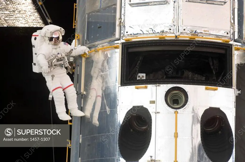 Astronaut performs work on the Hubble Space Telescope