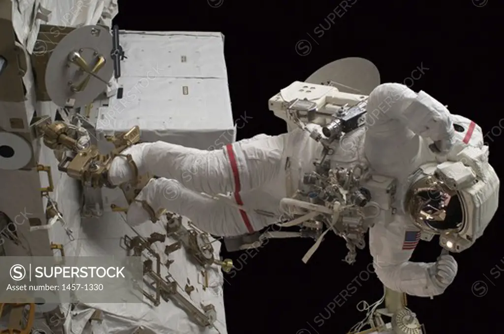 Astronaut participates in a session of extravehicular activity (EVA), International Space Station