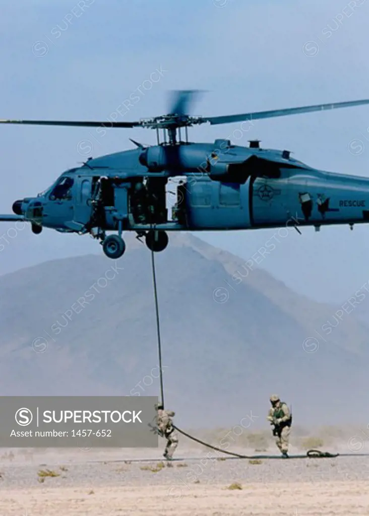 Soldier rappelling from a military helicopter, Indian Springs Air Force Auxiliary Air Field, Nevada, USA