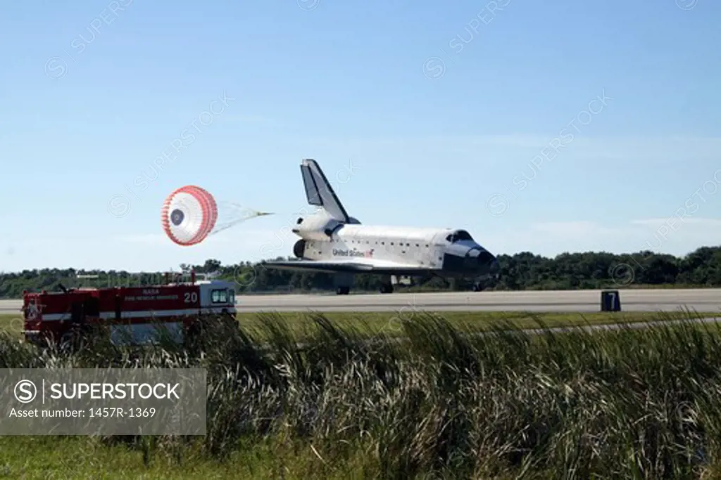 Space shuttle Atlantis unfurls its drag chute upon landing at Kennedy Space Center, Florida.