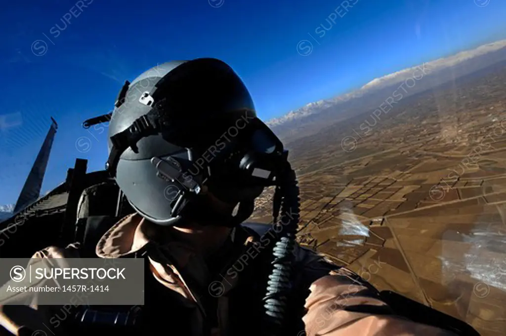 U.S. Air Force Aerial Combat Photographer watches for threats to a F-15E Strike Eagle.