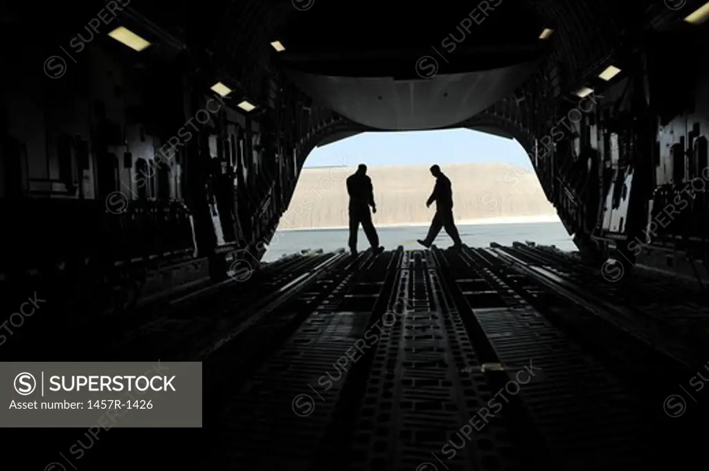 C-17A Globemaster III loadmasters go through prefight checks on the ramp.
