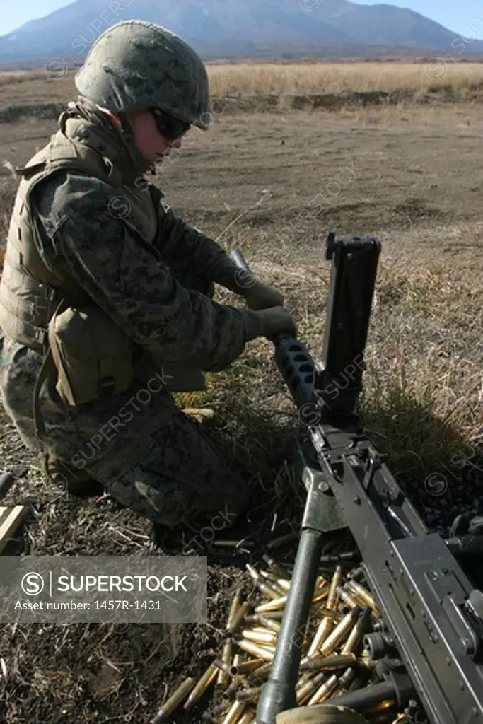 A soldier changes the barrel of an M2 .50 caliber machine gun.