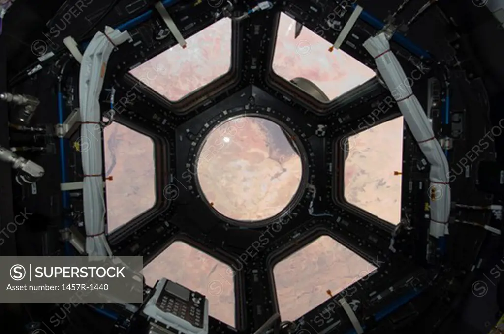 The Sahara Desert visible through the windows of the cupola on the Tranquility module.