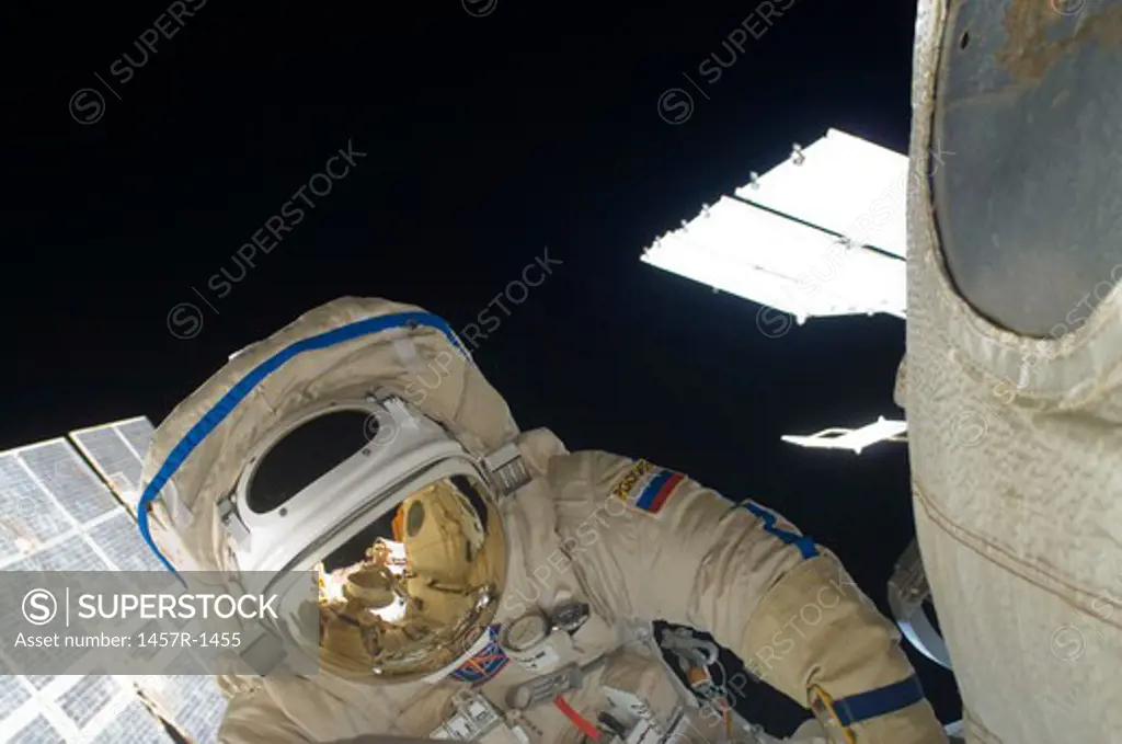 Russian cosmonaut performs a spacewalk.