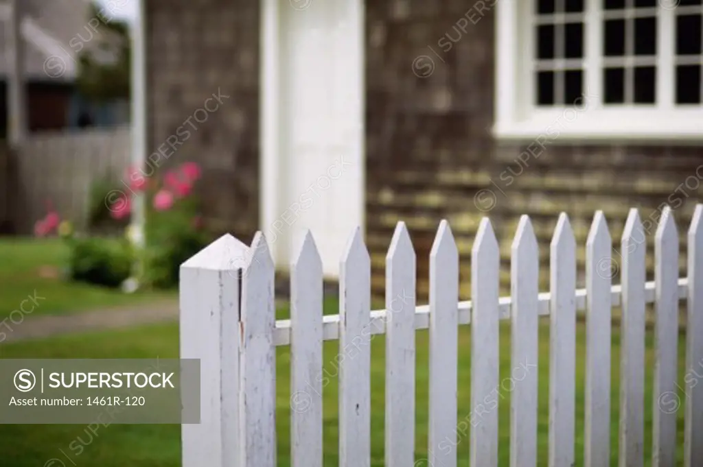 White picket fence in front of a house
