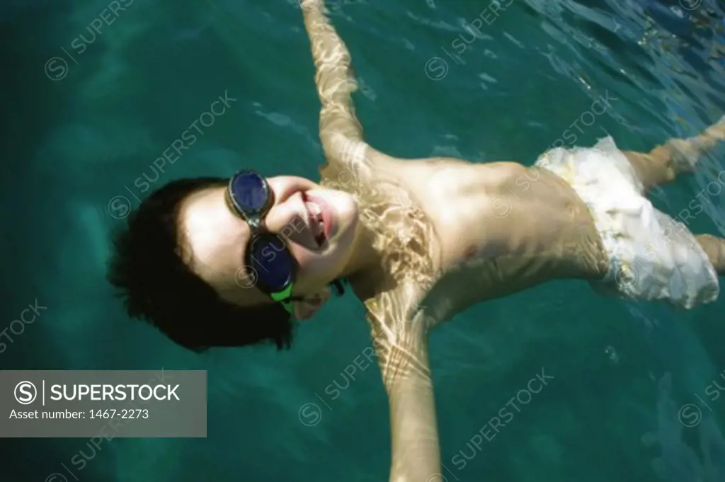 High angle view of a boy floating in a swimming pool