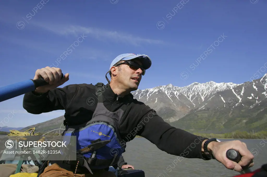 Mid adult man rafting in the river, Dezadeash River, Yukon, Canada