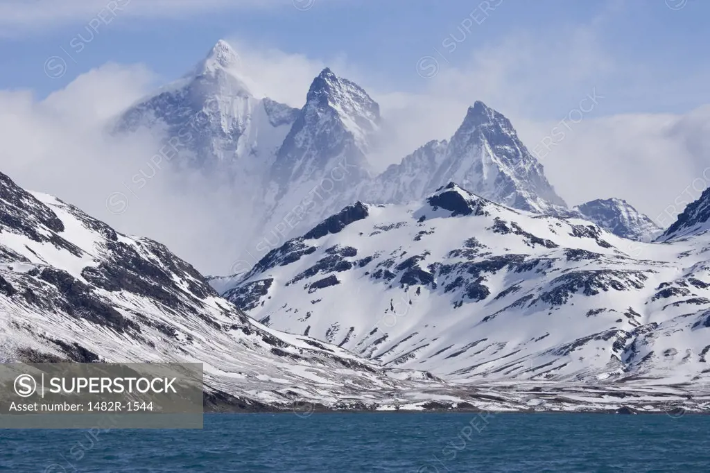 Snow covered mountains at the coast, Three Brothers, South Georgia Island, South Sandwich Islands