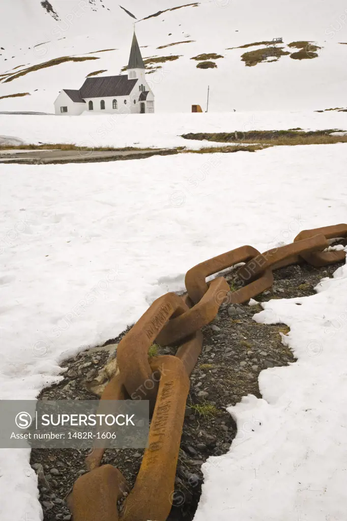 Rusty chain with a church in background, Grytviken, South Georgia Island, South Sandwich Islands