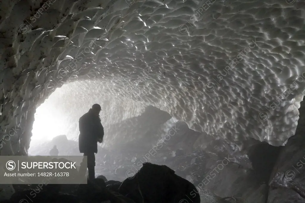 Person in an ice cave, Fiordland Recreation Area, Fiordland Conservancy, British Columbia, Canada