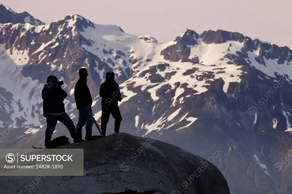 Hikers on a hilltop, Reid Glacier, Glacier Bay National Park, Alaska, USA