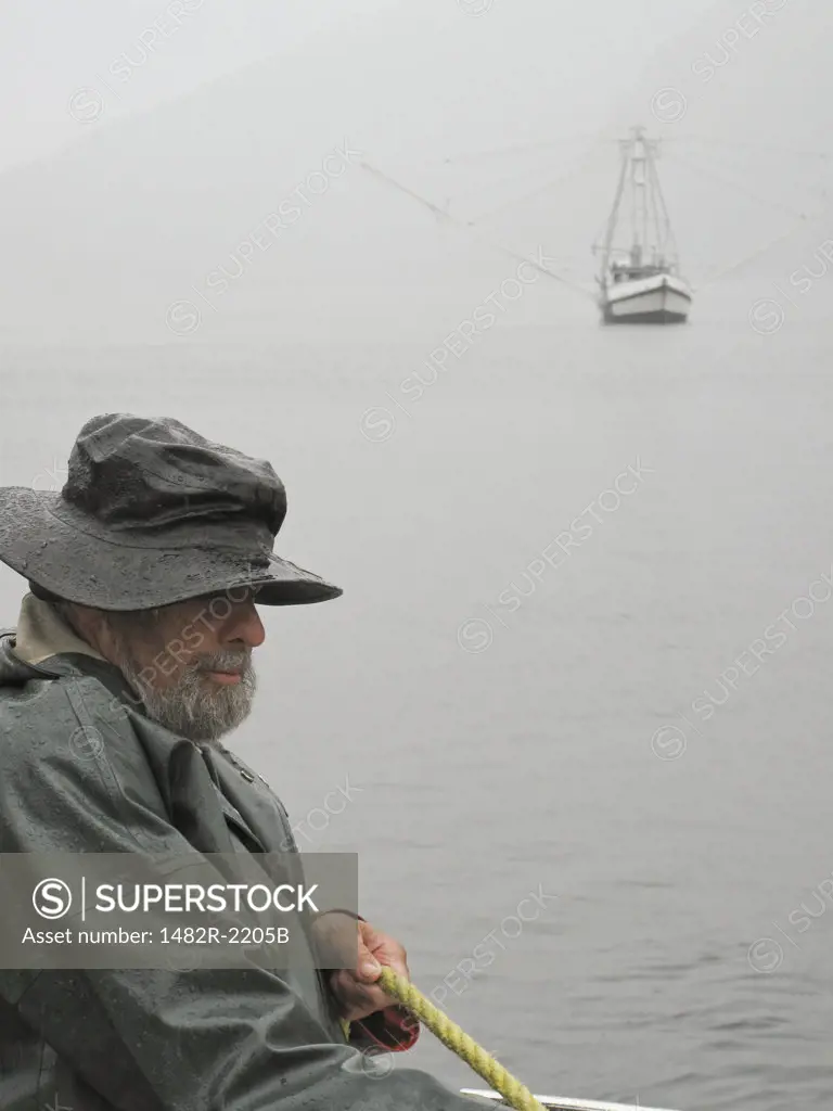 Fisherman in a boat, Warm Springs Bay, Baranof Island, Alaska, USA